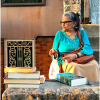 Nilda Serrano sits on stoop